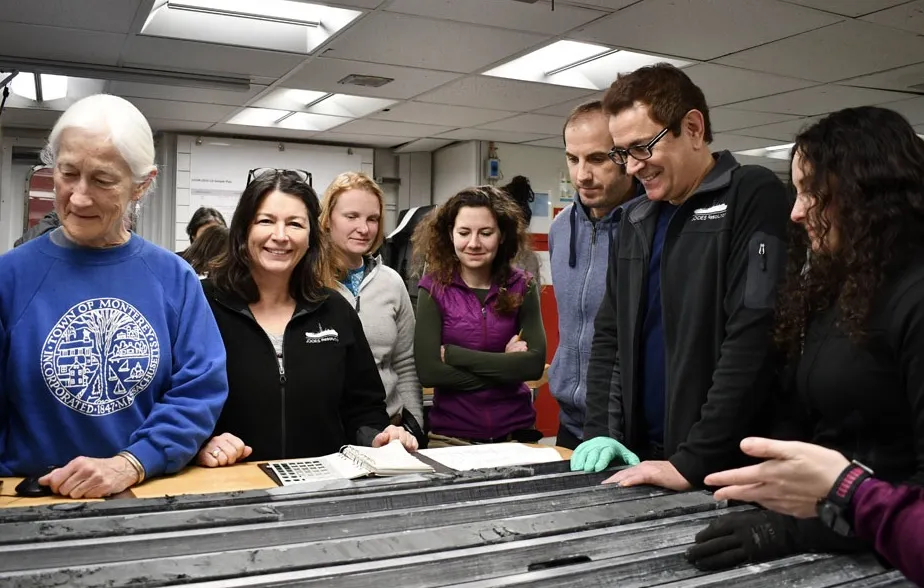 New sediment cores bring smiles to the core laboratory on the Joides Resolution. Maureen Raymo, co-chief scientist, is second from left. (Photo: Marlo Garnsworthy & IODP)