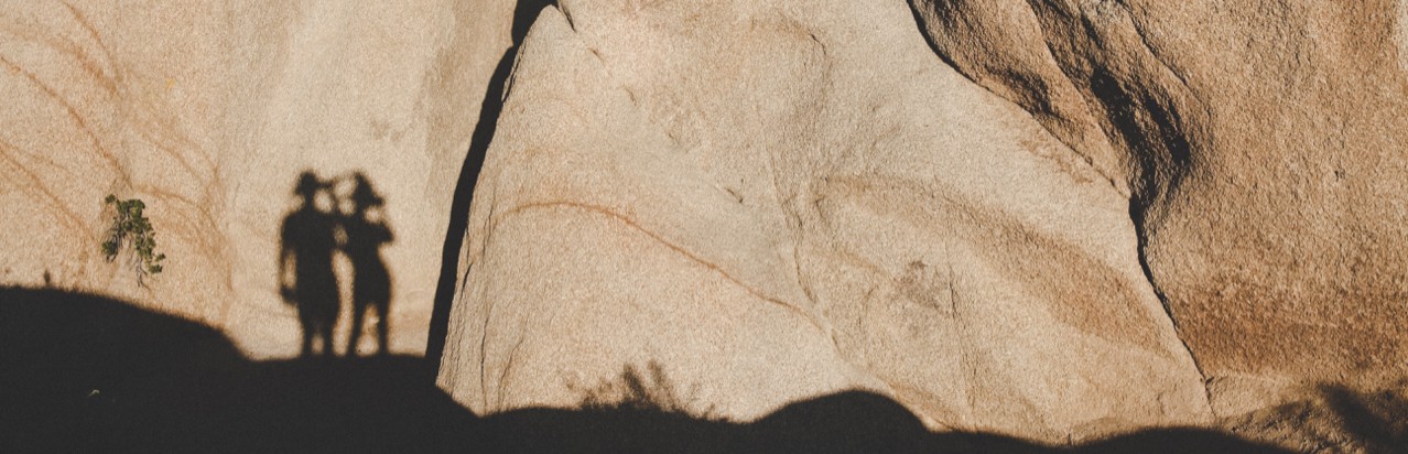 Human shadows on red rocks