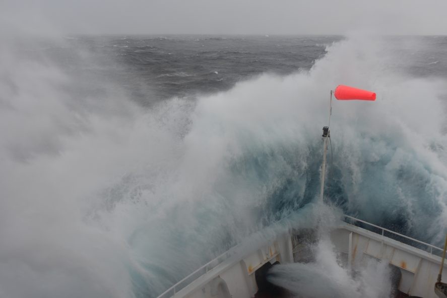 The bow of the Joides Resolution plunges into stormy seas during a storm the ship encountered during Expedition 383. (Photo: Christina Riesselman) The bow of the Joides Resolution plunges into stormy seas during a storm the ship encountered during Expedition 383. (Photo: Christina Riesselman)