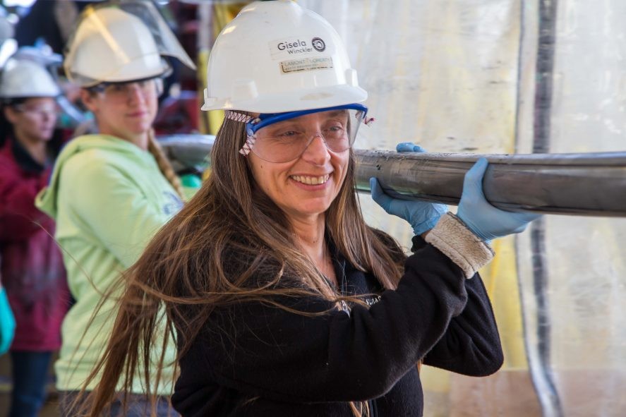 Gisela Winckler carrying a sediment core during IODP Expedition 383. (Photo: Tim Fulton & IODP)