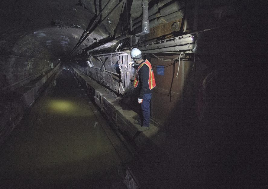 A Metropolitan Transportation Authority employee inspects flooding in the L train tunnel under the East River in New York City. The tunnel was flooded during the unprecedented 13-foot storm surge of Hurricane Sandy. (Photo: MTA of New York)
