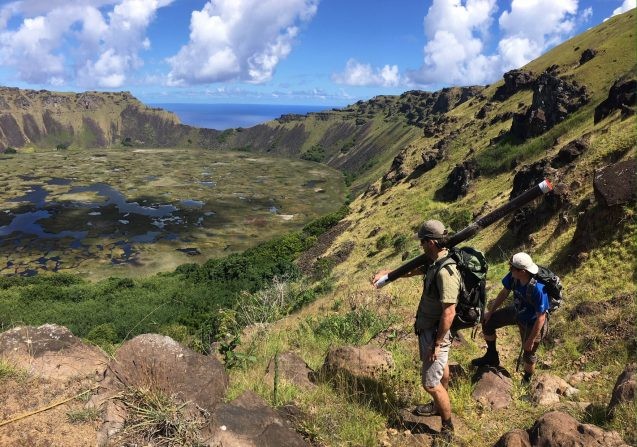 Nicholas Balascio and James Van Hook admiring Rano Kau while hiking out with one of many sediment cores. (Photo: Billy D’Andrea)