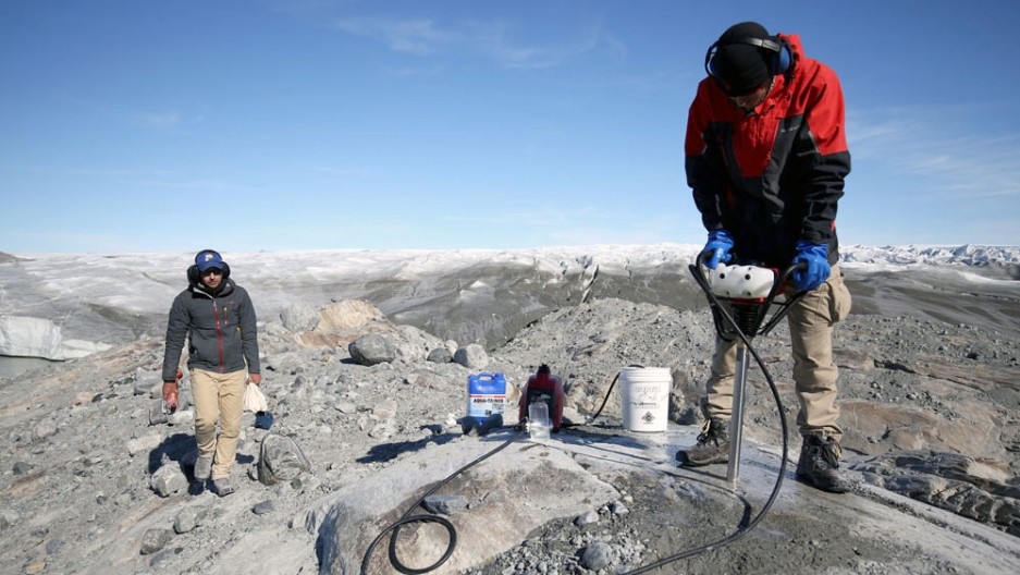 Researchers drill a core sample in Greenland. Their research has shown that the island has spent much of the last million years completely ice-free — which challenges what scientists thought they knew about Greenland. (Photo courtesy of Jason Briner)