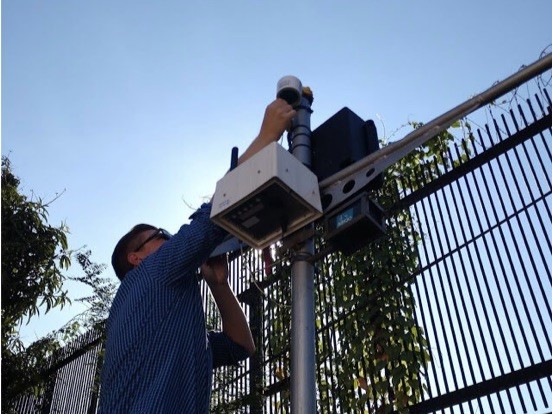 Dan Westervelt setting up low-cost air quality monitors at the U.S. Embassy in Kampala, Uganda; these are co-located with the embassy’s reference-grade air quality monitor.