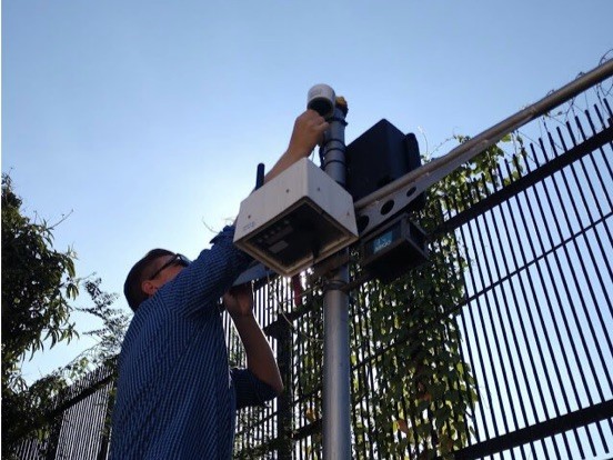 Dan Westervelt setting up low-cost air quality monitors at the U.S. Embassy in Kampala, Uganda; these are co-located with the embassy’s reference-grade air quality monitor. Dan Westervelt setting up low-cost air quality monitors at the U.S. Embassy in Kampala, Uganda; these are co-located with the embassy’s reference-grade air quality monitor.